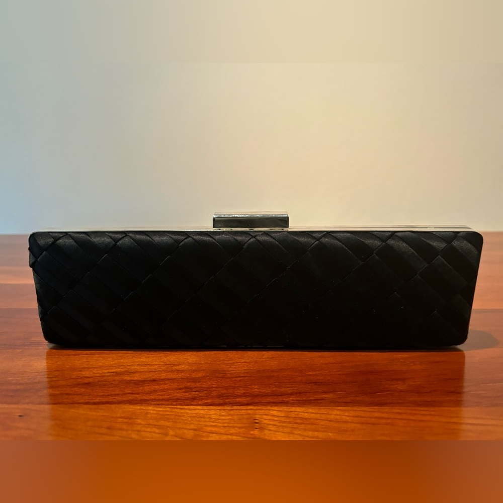Glint clutch with stainless accents and ribbon design